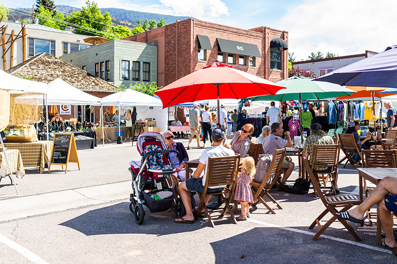 people-resting-sitting-at-tables-with-umbrellas